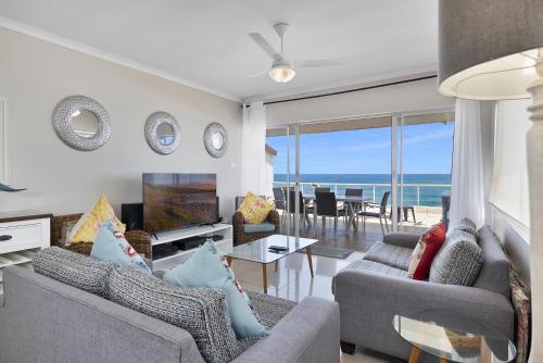 a living room with a view of the ocean at Driftwood 15 in Ballito