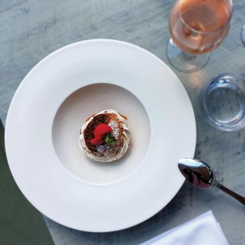 a white plate with a dessert on a table at Hôtel Lyon Métropole in Lyon