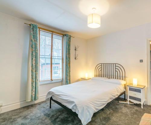 a bedroom with a bed and two night stands and a window at Minster Hub - 2 Min Walk 2 Minster! in York