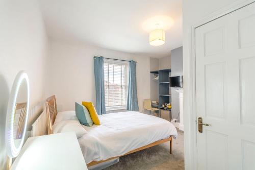 a small bedroom with a bed and a window at Minster Hub - 2 Min Walk 2 Minster! in York