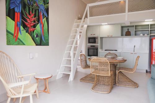 a kitchen with a table and chairs and a ladder at Øko Villa in Juquei