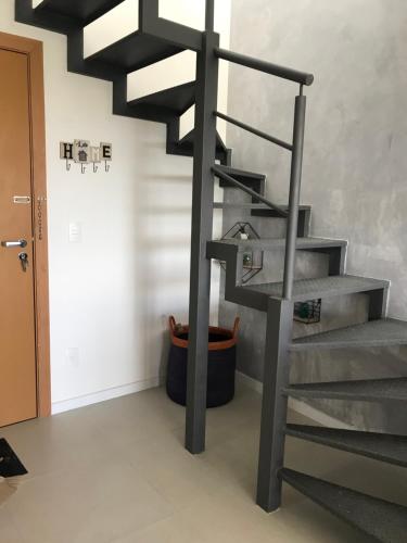 a metal spiral staircase in a room at Condomínio Paraiso dos Coqueiros in Camaçari