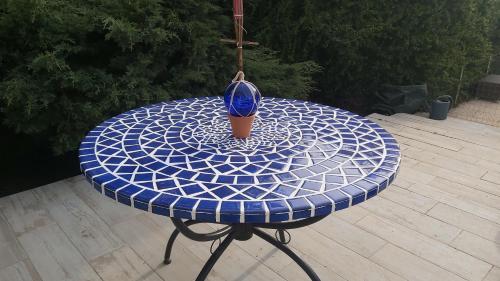 a blue table with a vase on top of it at Les loges in Parthenay