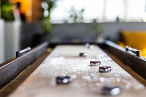 a wooden bench with four metal knobs on it at Pier 5 Hotel in Aalborg