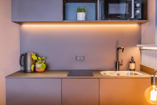 a kitchen with a sink and a counter top at Pier 5 Hotel in Aalborg