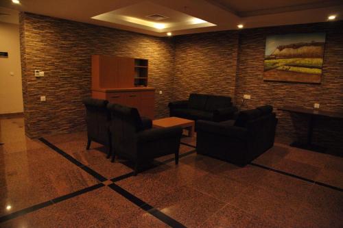 a waiting room with two chairs and a table at Merci Hotel Erbil in Erbil