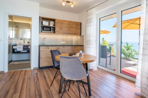 a kitchen and dining room with a table and chairs at Gästehaus am Bodensee in Immenstaad am Bodensee