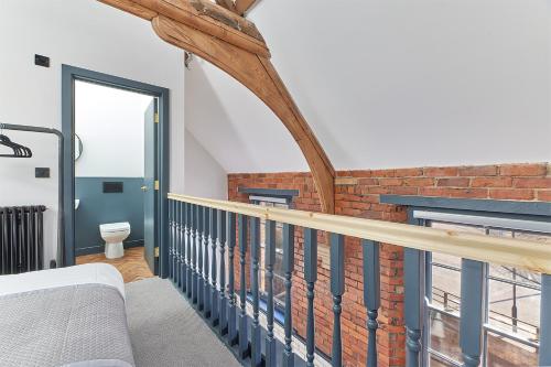 a room with a balcony with a brick wall at No 6 at Simpson Street Apartments Sunderland in Sunderland