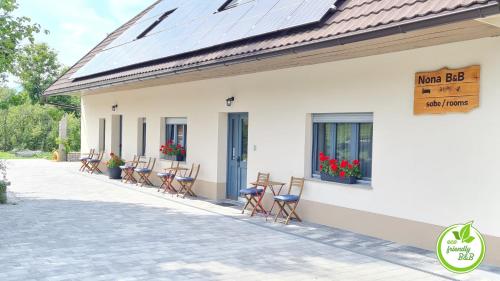 a group of chairs sitting outside of a building at Nona BB in Postojna