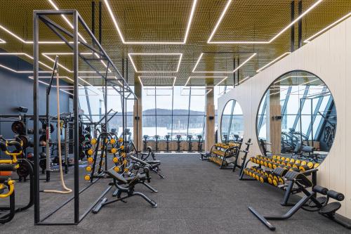 a gym with rows of treadmills and machines at Emily Resort in Lviv