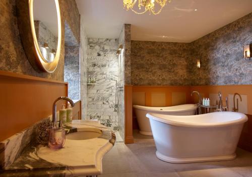 a large bathroom with a tub and a sink at Homewood Hotel & Spa - Small Luxury Hotels of the World in Bath