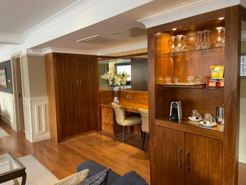 a living room with a wooden cabinet and a table at The Liner at Liverpool in Liverpool