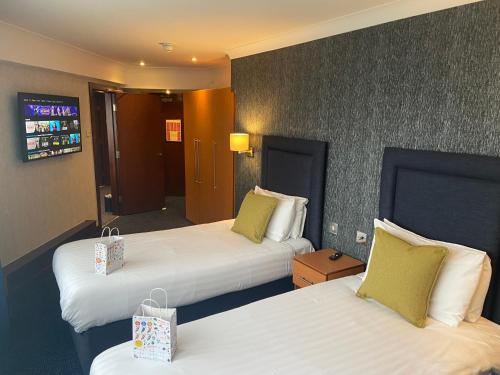 a hotel room with two beds and a hallway at The Liner at Liverpool in Liverpool