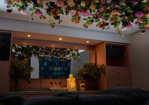 
a living room with a flower arrangement on the wall at Homewood Hotel & Spa in Bath
