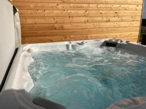 a jacuzzi tub with blue water in it at North Coast Escapes in Thrumster