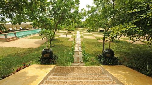 a stairway leading to a swimming pool in a park at NIKARA Luxury Beach House in Tissamaharama