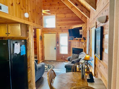a living room with a refrigerator and a table at Beary Charming in Gatlinburg