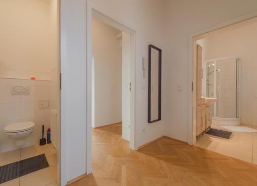 a white bathroom with a toilet and a sink at Schönbrunn Palace Beautiful 1 bedroom apartment in Vienna