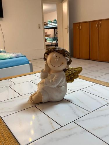 a small angel figurine sitting on a kitchen floor at Sions große Ferienwohnung beim Europapark Rust in Kappel-Grafenhausen