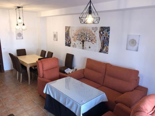 a living room with a couch and a table at LA CASITA DE EL BOSQUE in El Bosque