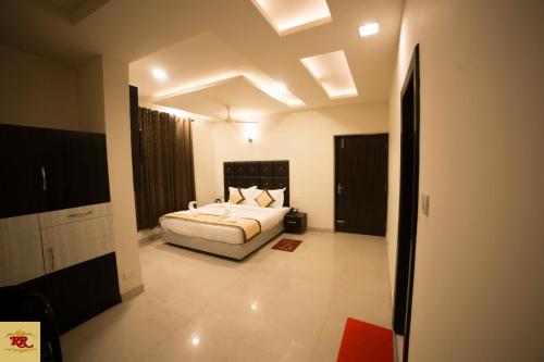a bedroom with a bed and a ceiling with lights at ROYAL ROSETTE LAKE VIEW Bhimtal in Nainital