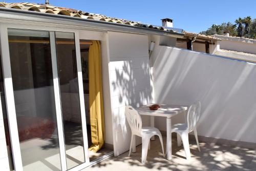 a white table and two chairs on a balcony at Villa Aurea in Ispica