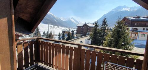 a balcony with a view of a snow covered mountain at Paradise Lodge in Livigno