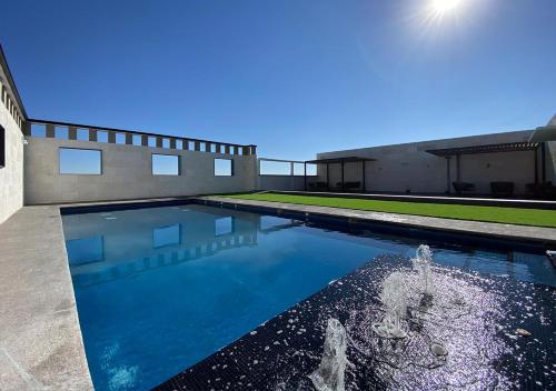 a swimming pool in front of a house at Hotel MX más san miguel de allende in San Miguel de Allende