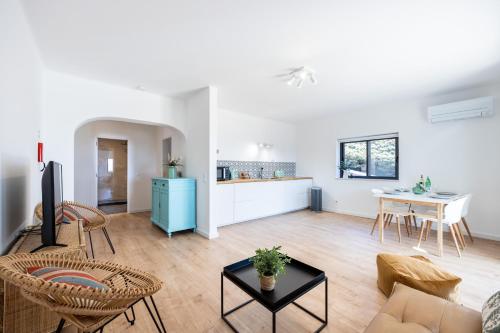 a living room with a couch and a table at Fortaleza sea view Villa Miramar - Downstairs Apartment II in Burgau
