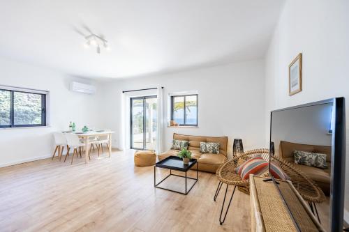 a living room with a couch and a table at Fortaleza sea view Villa Miramar - Downstairs Apartment II in Burgau