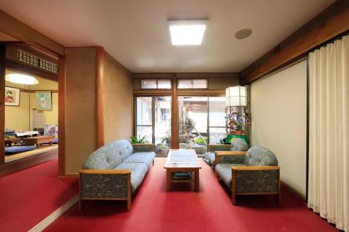 a living room with two couches and a table at Yudanaka Seifuso in Yamanouchi