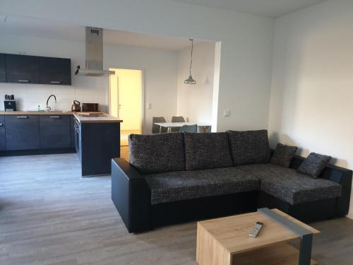 ein Wohnzimmer mit einem Sofa und einer Küche in der Unterkunft Quaduxenbarg - a65754 in Rüggow