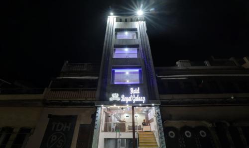 a tall building with a light on top at night at Itsy Hotels Royal Galaxy - 3 km From Sangam in Jahāngīrābād