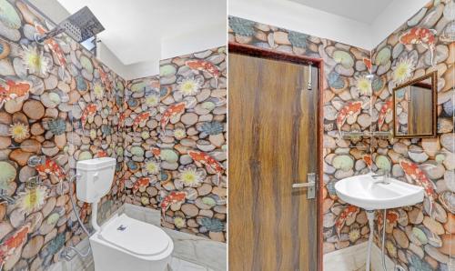 a bathroom with a stone wall with a toilet and a sink at Itsy Hotels Royal Galaxy - 3 km From Sangam in Jahāngīrābād