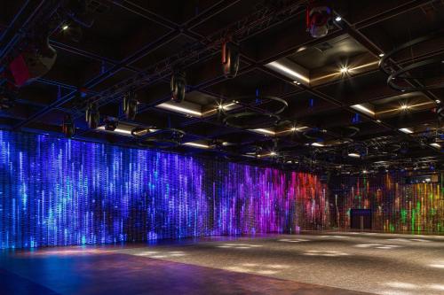 an empty stage with a colorful wall at Emily Resort in Lviv