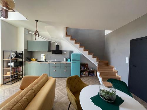 a living room with a couch and a table at Apartament Przystań in Mechelinki