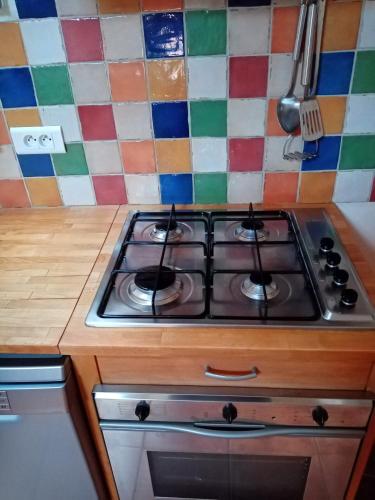a stove top oven sitting inside of a kitchen at Gîte passiflore in Frigoulet