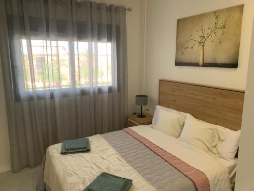 Un dormitorio con una cama grande y una ventana en Casa Kadanza, en Alhama de Murcia