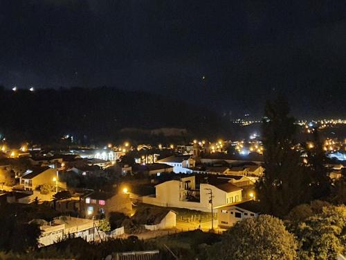a city lit up at night with lights at San Benito Hotel in Tibasosa