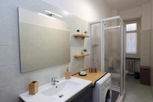 a bathroom with a sink and a shower at Maison Christine in Turin