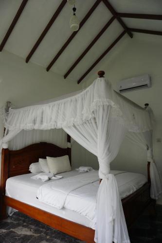 Ένα ή περισσότερα κρεβάτια σε δωμάτιο στο JungleRiverHouse & JungleRiverResort