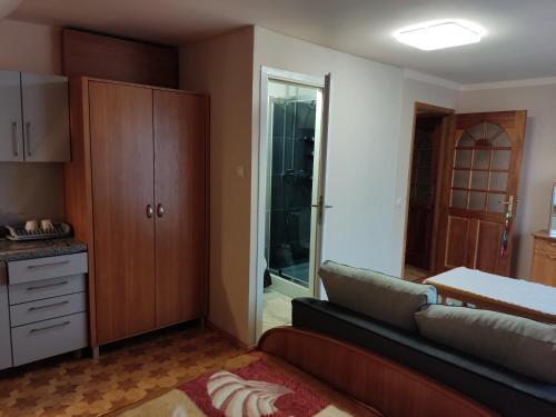 a living room with a couch and a sliding glass door at Podelniska in Porąbka