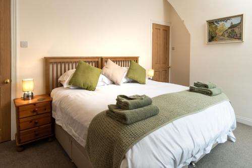 a bedroom with a bed with towels on it at CRAVEN VUE - SKIPTON in Skipton