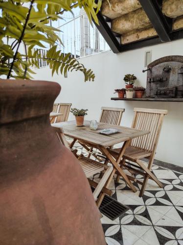 a wooden table and chairs in a room at Casa de São Bento by PURUS in Coimbra