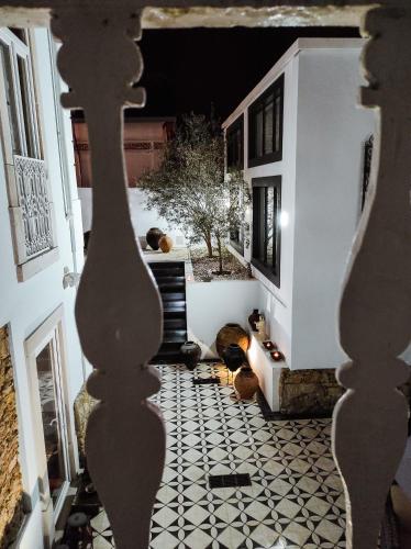 a hallway with a tiled floor in a house at Casa de São Bento by PURUS in Coimbra