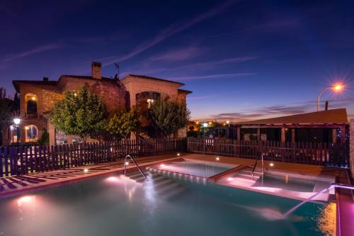 a swimming pool in front of a building at night at El Mirador De Ruidera in Ruidera