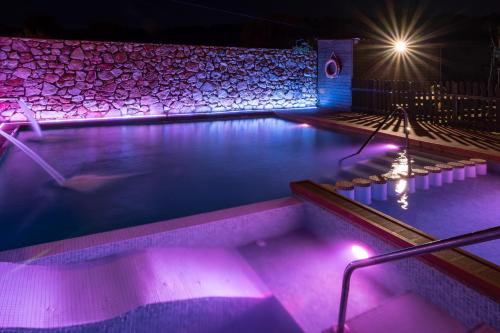 a swimming pool at night with a person in it at El Mirador De Ruidera in Ruidera