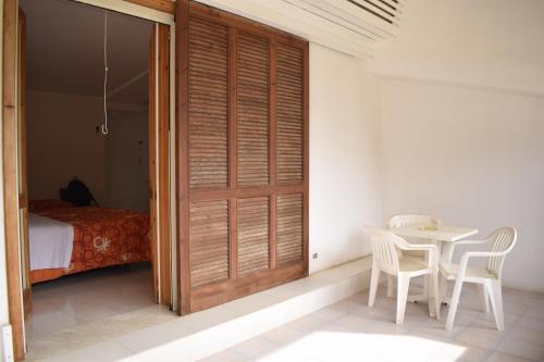 a room with a door and a table and a bed at Villa Aurea in Ispica
