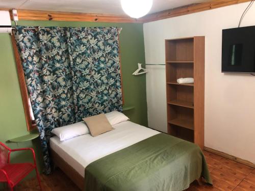 a bedroom with a bed and a dresser at Cabinas Cahuita in Cahuita