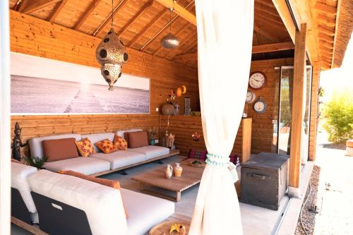 a living room with a couch and a table at Seeds of Silence boutique wellbeing hotel near Olhao Faro in Olhão